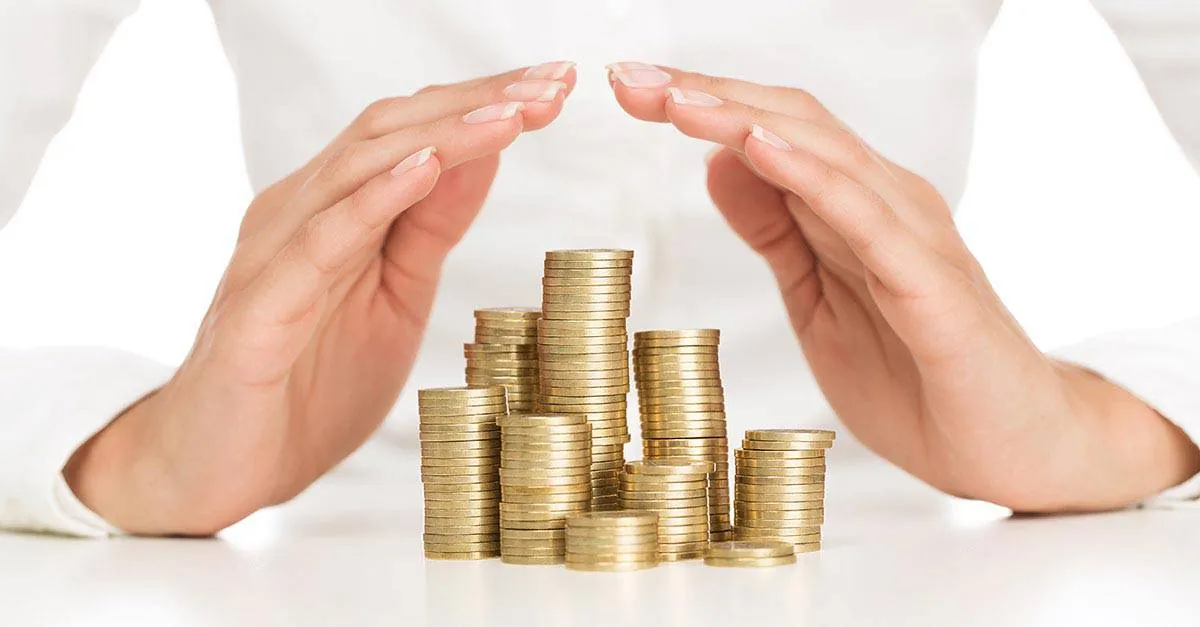 Hands shielding stacks of coins illustrating the regulated finance sector